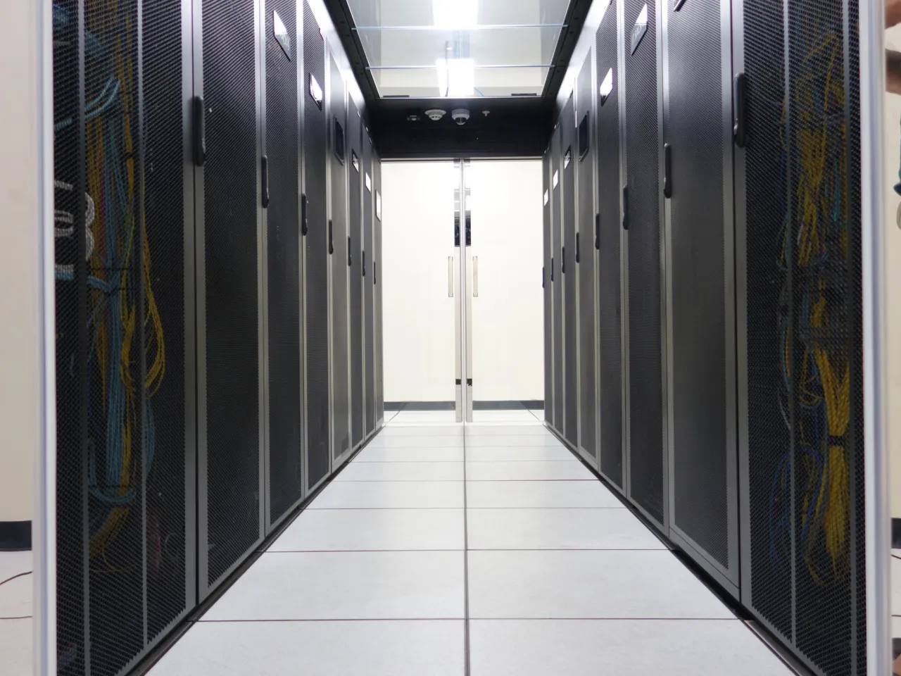 Server racks in a data centre with an Isle of Man branch overlaid on a map