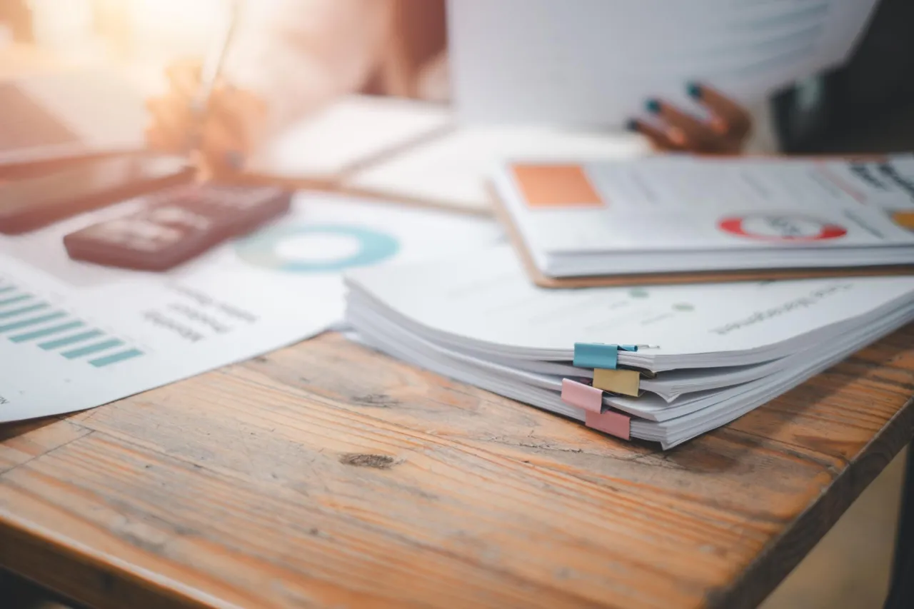 A document review on a desk in muted blue tones