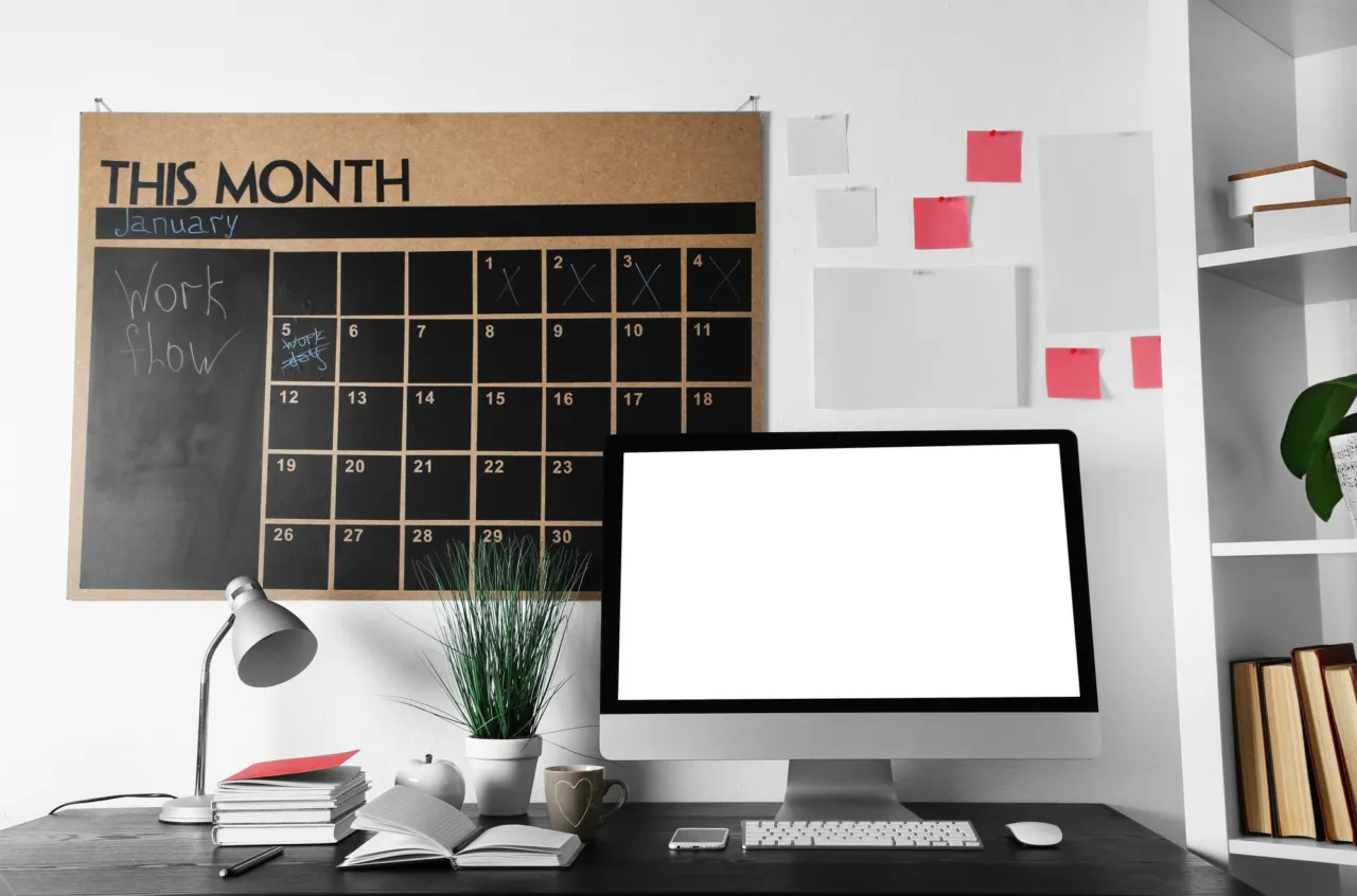 A wall planner and documents on a desk, marking an approaching compliance deadline