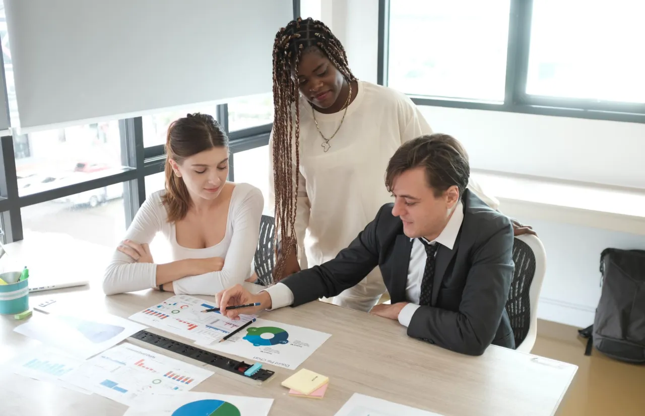 Colleagues talking through a firm's internal reporting process at a desk