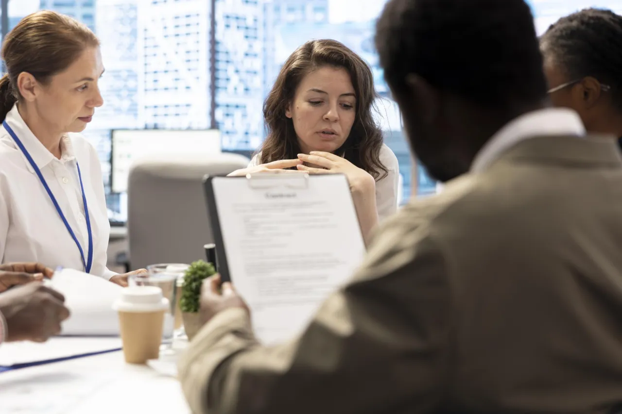 A compliance team reviewing an incident report in a meeting room