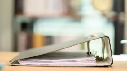 Isle of Man corporate documents and a compliance file on a navy desk