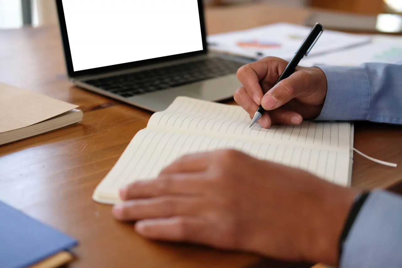 A recorded business risk assessment on a desk showing dated review notes in the margin