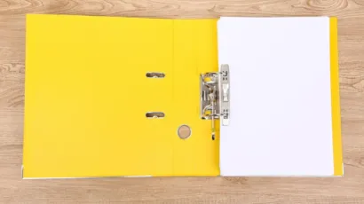 A compliance file open on a desk in a calm Isle of Man office
