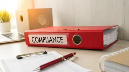 A compliance officer reviewing a sanctions screening list at a desk in an Isle of Man office