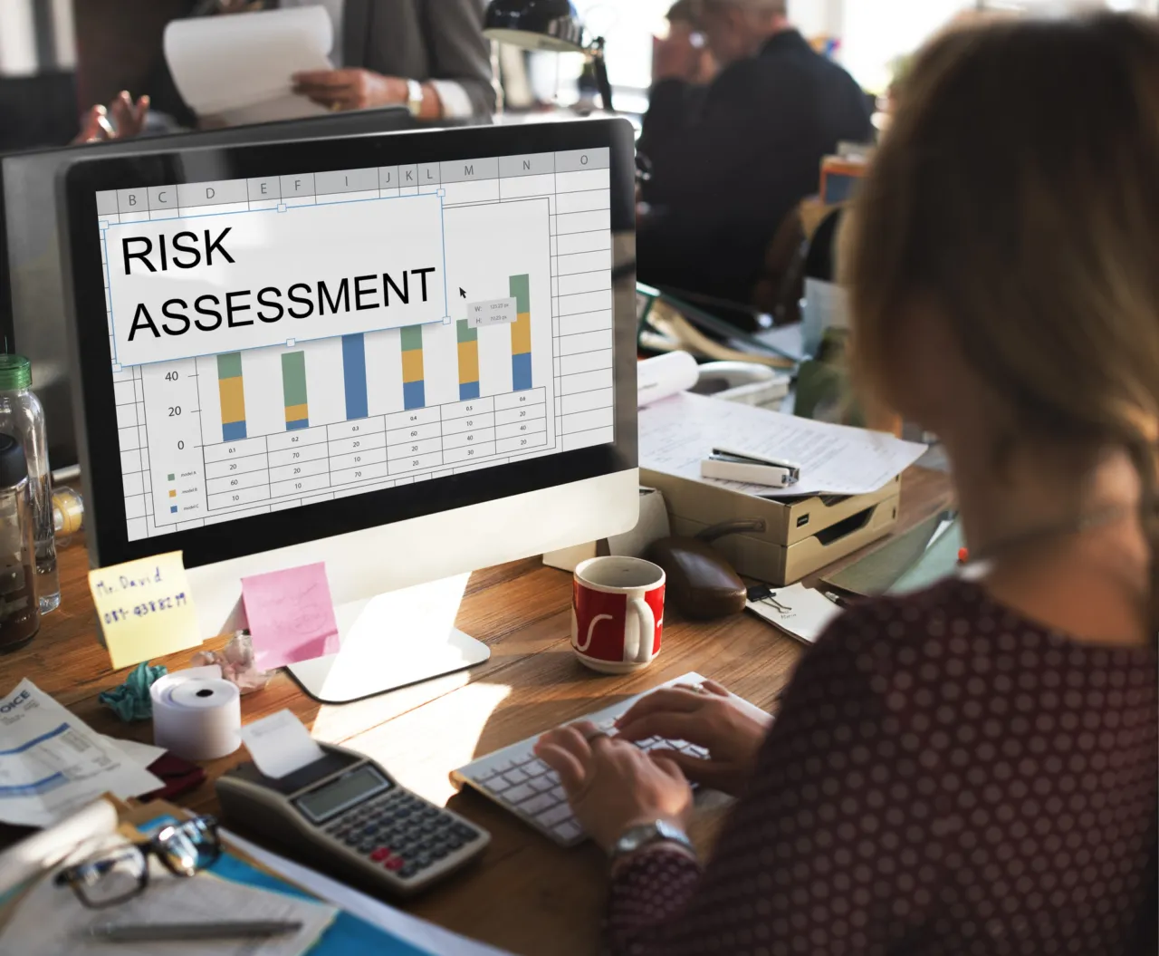 A risk meeting around a table with sanctions and compliance documents laid out