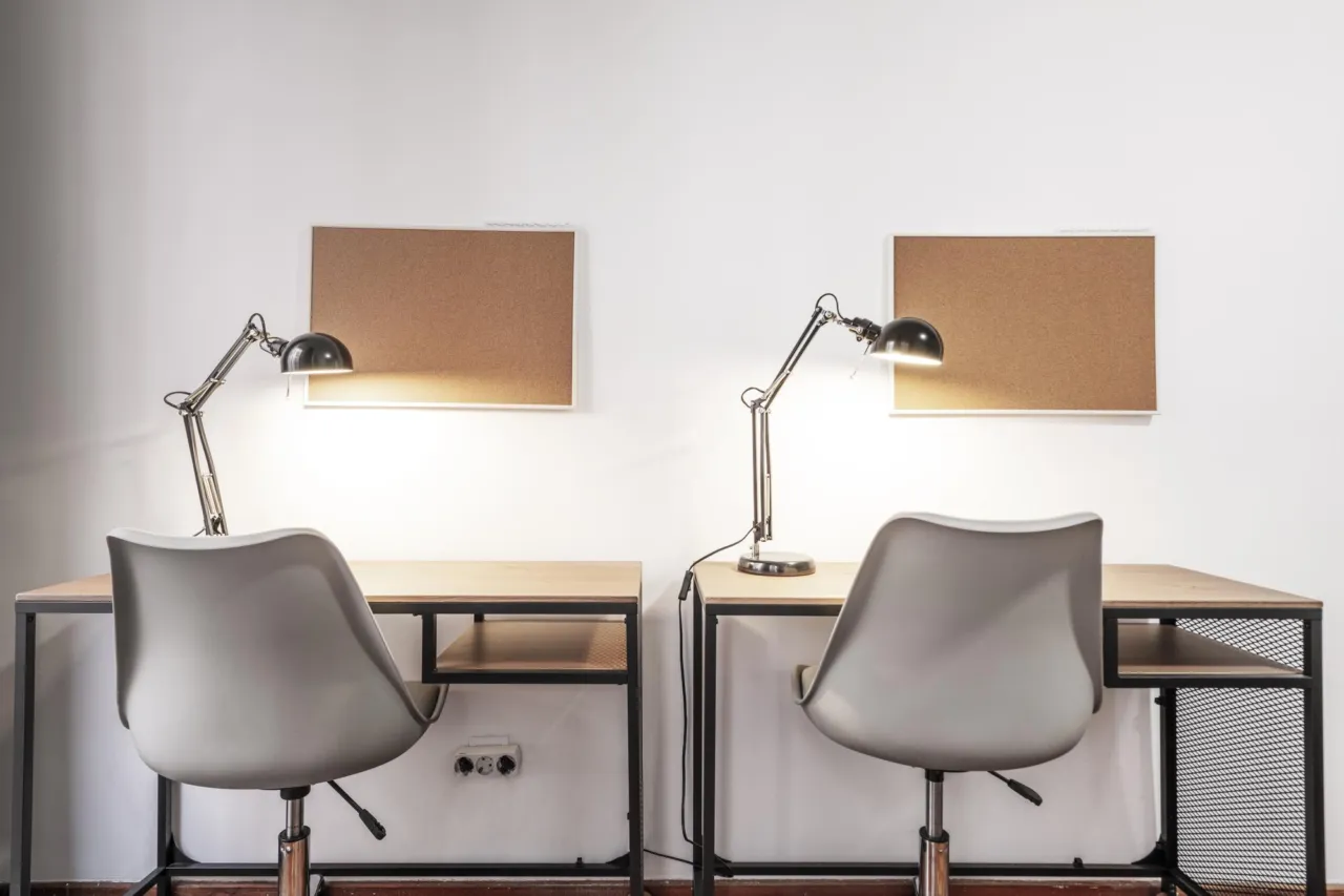 Two separate desks in a compliance office, one handling disclosures and one handling monitoring, illustrating the split of duties