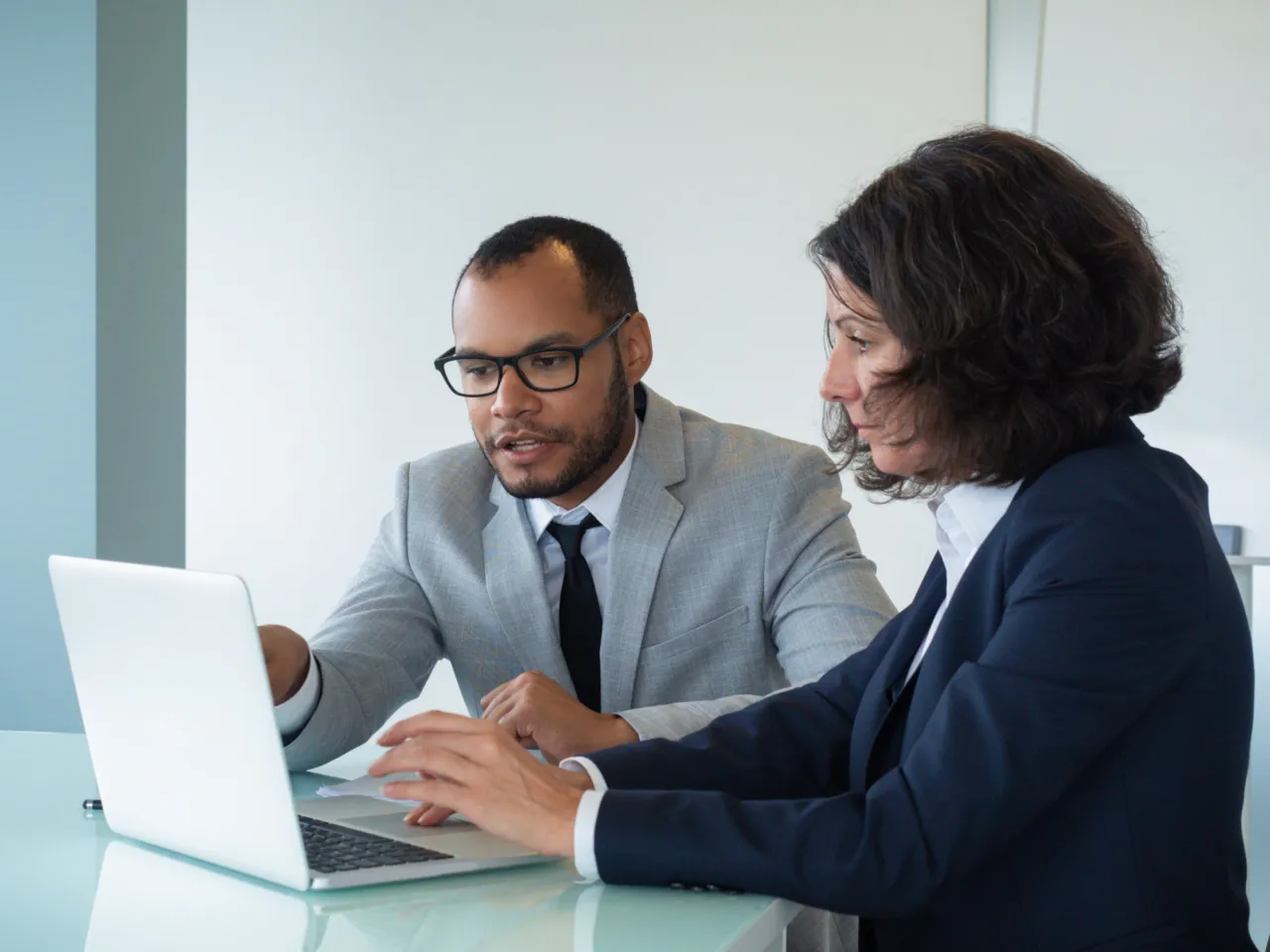 Two colleagues reviewing and discussing a report together