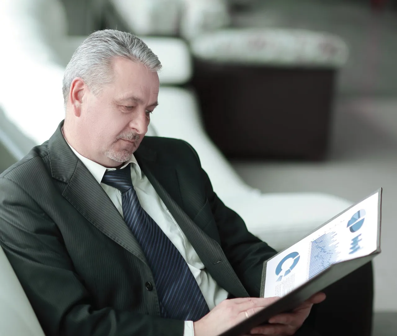 A senior manager reviewing figures on a tablet